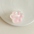 Detailansicht der rosa Katzenpfoten-Handyhalterung auf weißem Keramikteller - Transparenter Ständer-Leuchtende Katzenpfote / Rosa