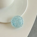 Close-up of a round blue glitter phone grip with silver sequins on a minimalist surface - Transparent Blue