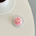 Macro detail of a pink plush ball phone grip with a white bow in Gift For You packaging - Rose Red