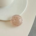 Close-up of a round glitter phone socket with sparkling sequins in a translucent brown finish - Transparent Brown