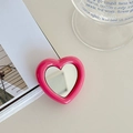 Close-up of pink heart-shaped expandable phone grip featuring a built-in makeup mirror - Rose Red