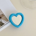 Close-up of a heart-shaped blue phone socket stand with an integrated silver mirror surface - Dark Blue