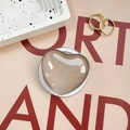 Macro view of champagne gold heart phone grip with reflective mirror finish and clear base - Grey Brown