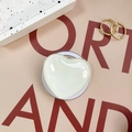 Detailed view of heart shaped magnetic phone grip in cream white with glossy finish - Beige