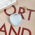 Detail of light blue heart-shaped retractable phone grip with translucent jelly texture - Light Blue