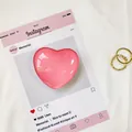 Dettaglio ravvicinato del supporto per telefono a forma di cuore rosa lucido su carta - Rosa