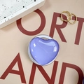 Macro shot of purple heart-shaped telescopic phone grip with smooth glossy resin finish - Purple
