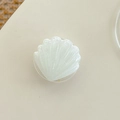 Close-up of pearl white shell-shaped phone grip with shimmering glitter texture - White