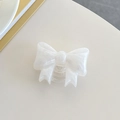 Detail of a white bow-shaped phone grip with pearl finish and transparent socket - Large Bowknot Stand - Pearlized - White