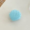 Detail of light blue shell phone grip with pearlescent glitter and 3D texture - Blue