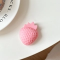 Macro view of a 3D pink strawberry phone grip with textured seeds on a white background - Soft Pink (Heart)