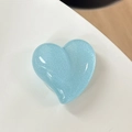 Macro shot of sky blue glitter heart-shaped phone grip with glossy resin finish - Pearlescent Blue