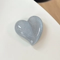 Detail of silver blue glitter heart phone grip featuring a smooth resin finish - Pearlescent Grey