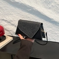 Black triangle crossbody bag with glitter sequin flap and white decorative stitching - Black