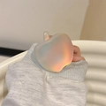 Close-up of translucent iridescent apple-shaped phone grip with aurora gradient effect - Adhesive Aurora Blue Apple Grip Tok