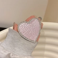 Close-up of pink heart phone grip with leather texture and sparkling rhinestone border - Pearlescent Texture Style / Pink