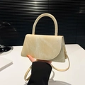 Trapezoidal faux suede handbag in beige with curved flap and gold metal hardware - Beige