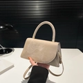 Minimalist beige suede trapezoid handbag with gold hardware and curved top handle - Khaki
