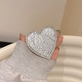 Sparkling silver textured heart phone grip stand with rhinestone borders held by a hand - Pearlescent Texture Style / Silver