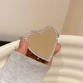 Close-up of heart phone grip featuring khaki leather texture and sparkling rhinestones - Khaki