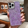Close-up of sparkling purple glitter phone case with silver metal camera lens protection - Purple