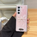 Detail of pink glitter phone case for Z Flip with bow and metallic logo plate - Matte Pearl Pink / Samsung ZFlip3
