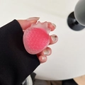 Detail of pink strawberry resin phone grip with textured surface and translucent finish - Rose Red