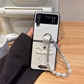 Close-up of leather flip phone case with polka dot bow and pearl carrying strap - White (Polka Dot Bow + Pearl Chain) / Samsung ZFlip3