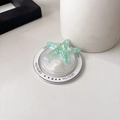Macro detail of mint green resin starfish phone grip with laser sequins and glitter finish - Magnetic Round Pearlescent Starfish / Green