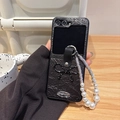 Close-up of black litchi leather case with bow and pearl rhinestone chain strap - Black (3D Bow + Pearl Chain) / Samsung ZFlip3