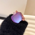 Detail of purple apple-shaped telescopic phone grip with matte iridescent finish - Bright Purple