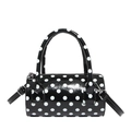 Chic cylindrical baguette bag with classic black and white polka dots in glossy finish - Black