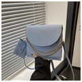 Detail of light blue crossbody bag with gold fashion text and mini pouch attachment - Blue