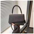 Elegant black crossbody bag with shimmering glitter flap and gold miss.mini branding - Black