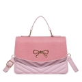 Pink crossbody bag with striped woven flap and gold bow detail for summer style - Pink