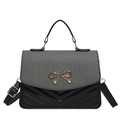 Black leather handbag with grey striped fabric flap and golden bow clasp accent - Black
