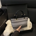 Handcrafted woven straw bucket bag with dark grey gradient texture and knot handles - Black
