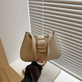 Minimalist beige shoulder bag with gold metal buckle in a bright modern setting - Khaki