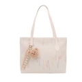 Chic beige tote bag with colorful wave embroidery and cute bear plush charm - White