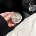 Detail of transparent phone socket with white pearl bowknot decoration held in hand - Adhesive Round Pearl Bow