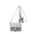 Minimalist blue and white crossbody bag featuring a silk bow and golden pendant - Blue