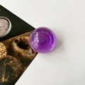 Macro detail of a purple transparent crystal ball phone grip with a glossy finish - Transparent Purple