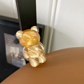 Close-up detail of a translucent amber textured bear shaped retractable phone grip stand - Water Ripple Bear (Translucent Orange)