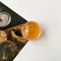 Macro detail of amber crystal ball phone grip with warm orange resin finish and shine - Transparent Orange