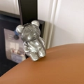 Macro view of a textured transparent grey bear-shaped expandable phone socket grip - Water Ripple Bear (Translucent Black)