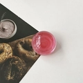 Detail of pink crystal ball phone socket with translucent finish on white leather - Translucent Red