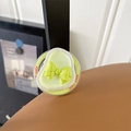 Detail of light green phone grip featuring a 3D yellow bow and Good Luck text - Iridescent Bow - Pearlescent Green