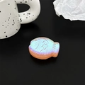 Detail of 3D fish phone grip with holographic glitter finish and artistic engraving - Orange