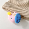 Dettaglio del supporto per telefono in peluche rosa con orecchie blu su maglia beige - Rosa