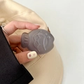 Close-up of translucent grey fish-shaped phone grip with creative minimalist details - Matte Light Jelly Grey
